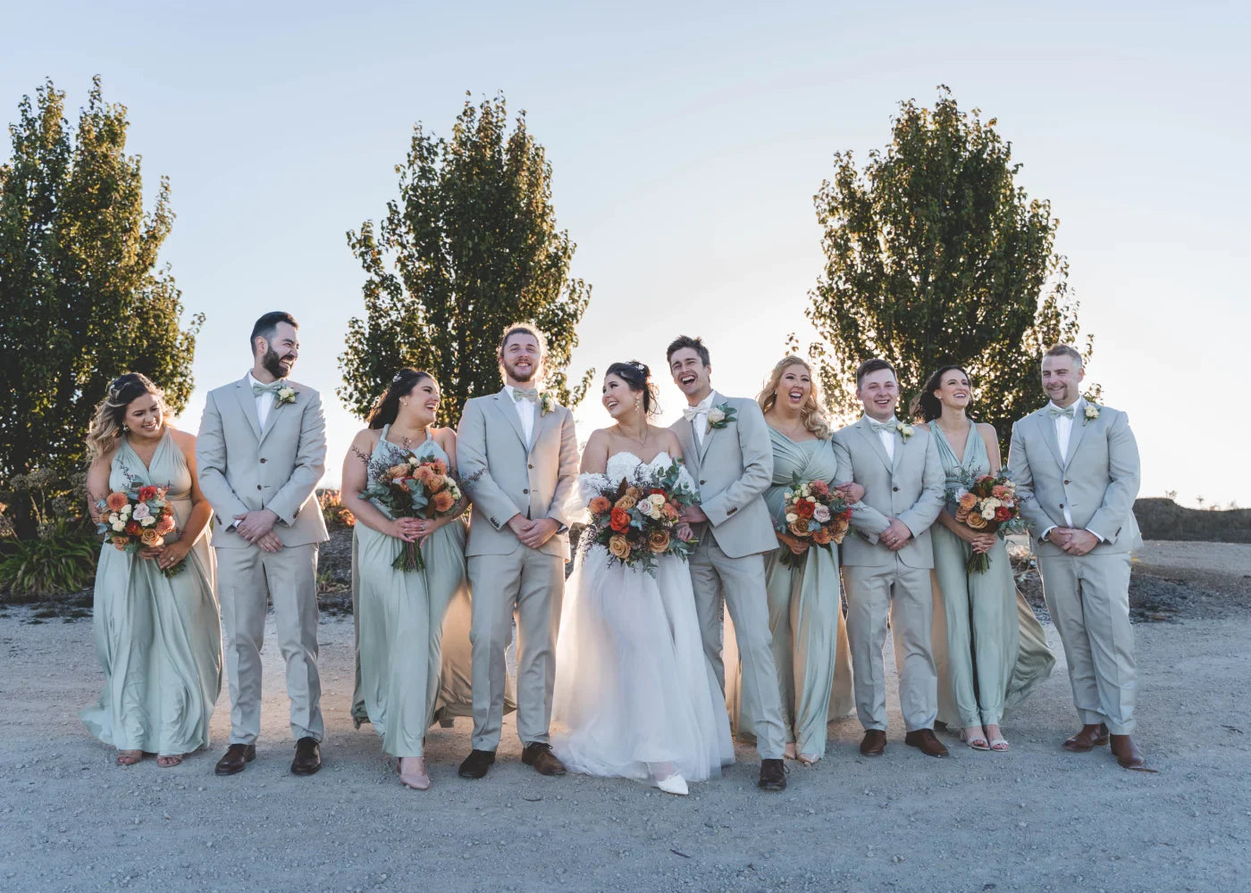 Diverse wedding party in Eucalyptus Infinity Gown and green bridesmaid dress