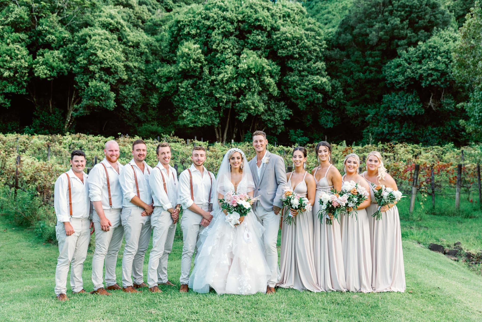 Bridal party in vineyard wearing Champagne Infinity Gown, a convertible champagne bridesmaid gown in Australia