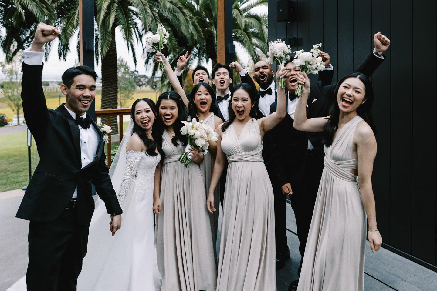 Joyful wedding attendees celebrating in a Champagne Infinity Gown, a versatile convertible dress Australia
