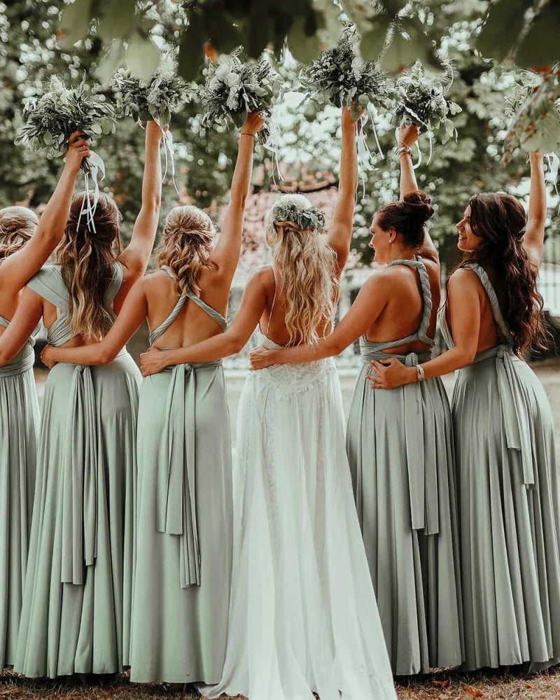 Women in Sage Green Infinity Gown and Convertible Dress, holding bouquets aloft