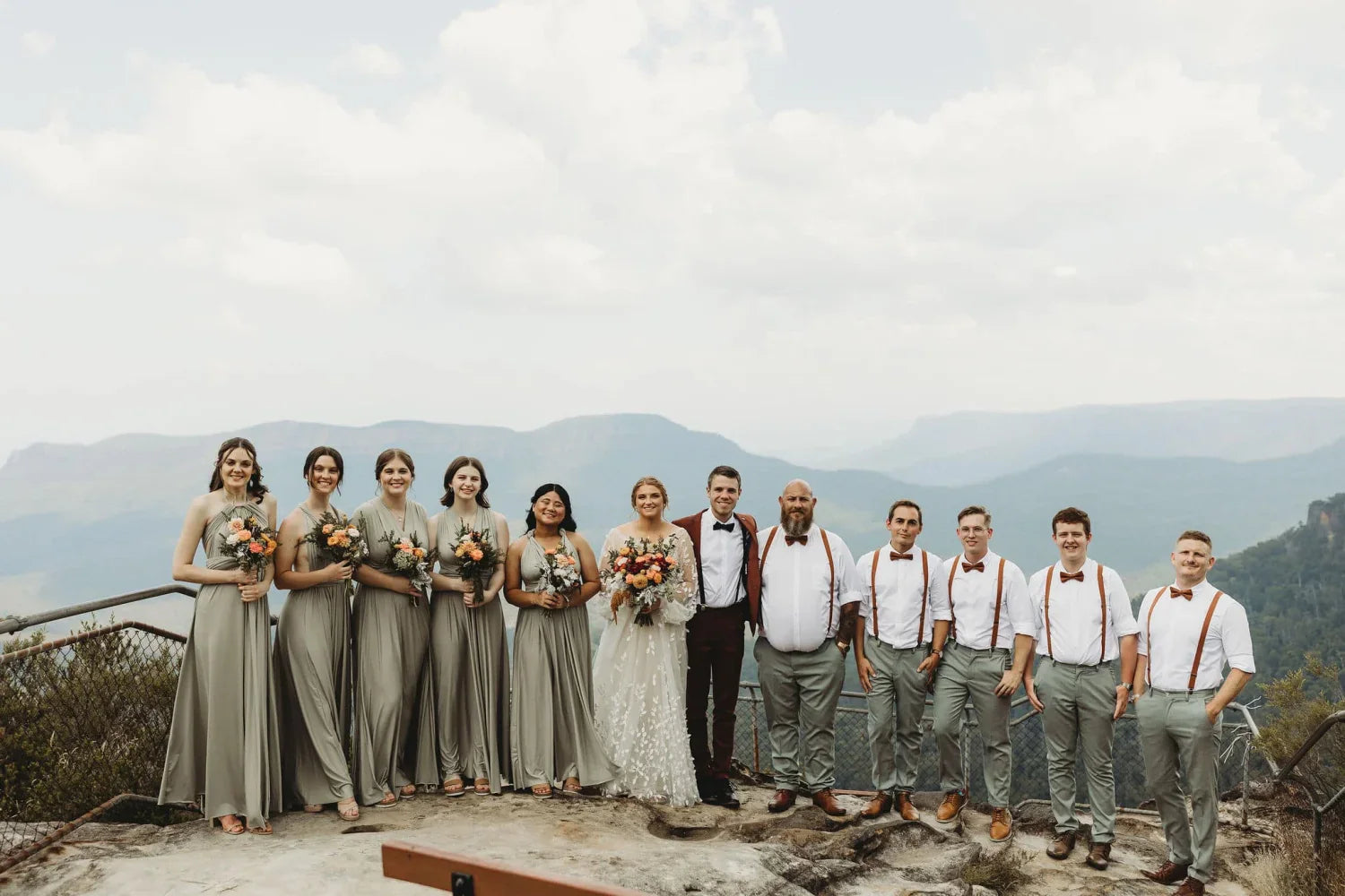 Bridal party outdoors wearing Eucalyptus Infinity Gown, a stylish convertible green bridesmaid dress