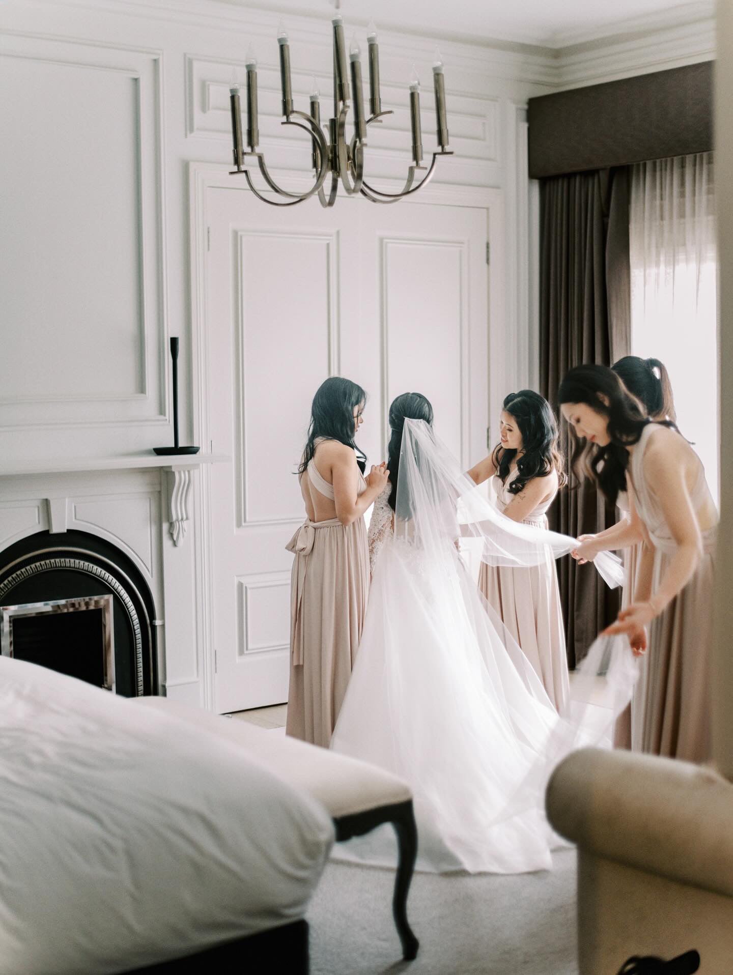 Bride in Champagne Infinity Gown with bridesmaids in light-colored multiway bridesmaid dresses