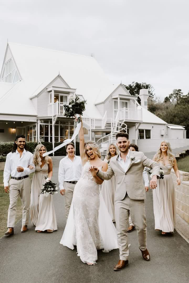Wedding party celebrating outdoors in a Champagne Infinity Gown, a stylish convertible dress Australia