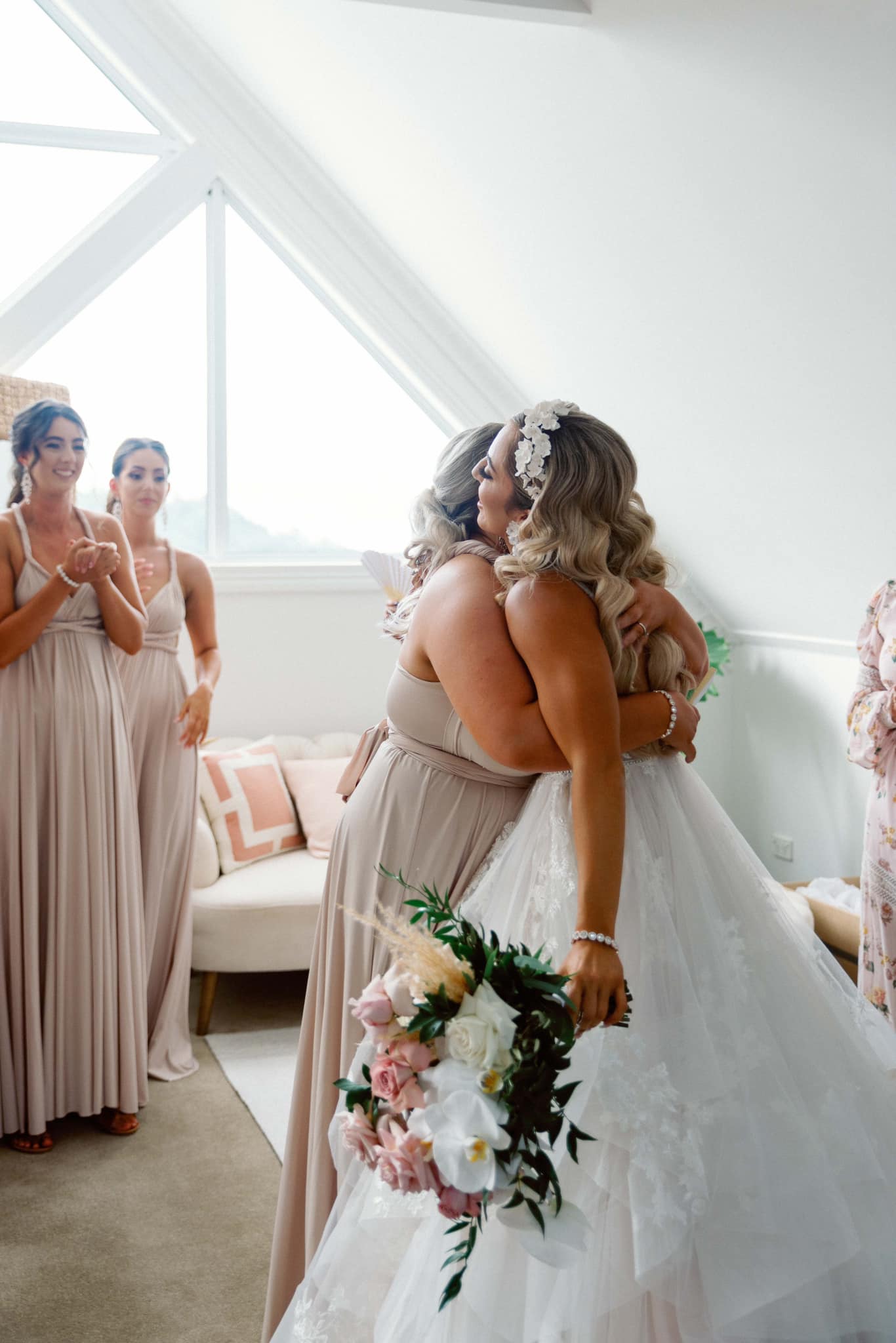 Two women embracing at wedding, one in Champagne Infinity Gown, convertible dress Australia
