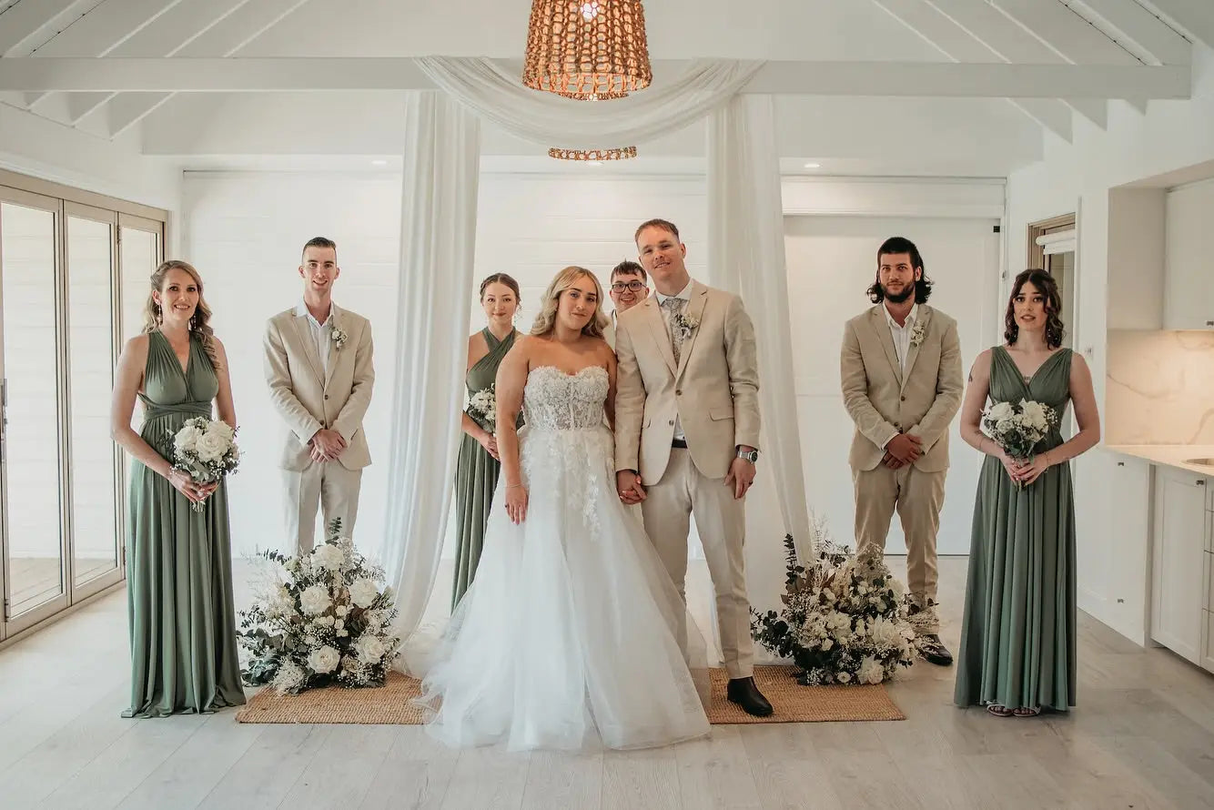 Wedding party with bride and groom wearing infinity dresses at Bella and Bray event