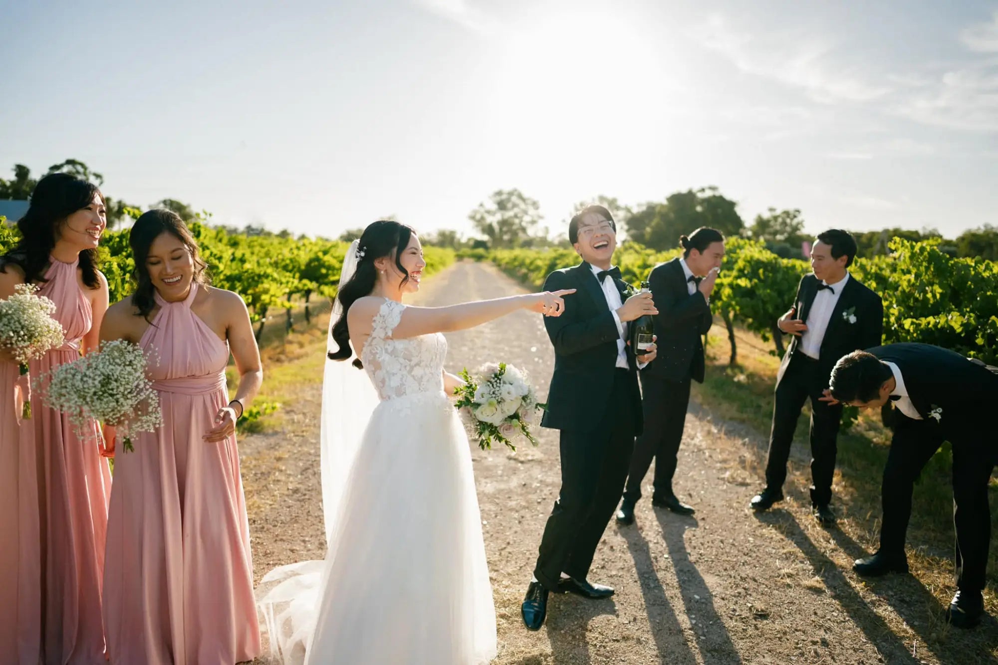 Lively wedding group celebrating in a vineyard with infinity dress Australia for bridesmaids
