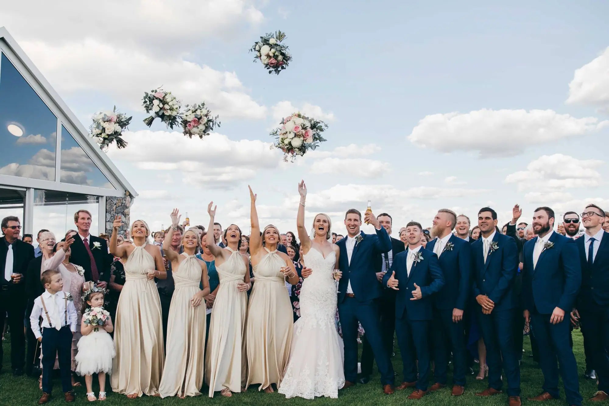 Wedding party throwing bouquets with infinity dress Australia at Chris and Bec celebration