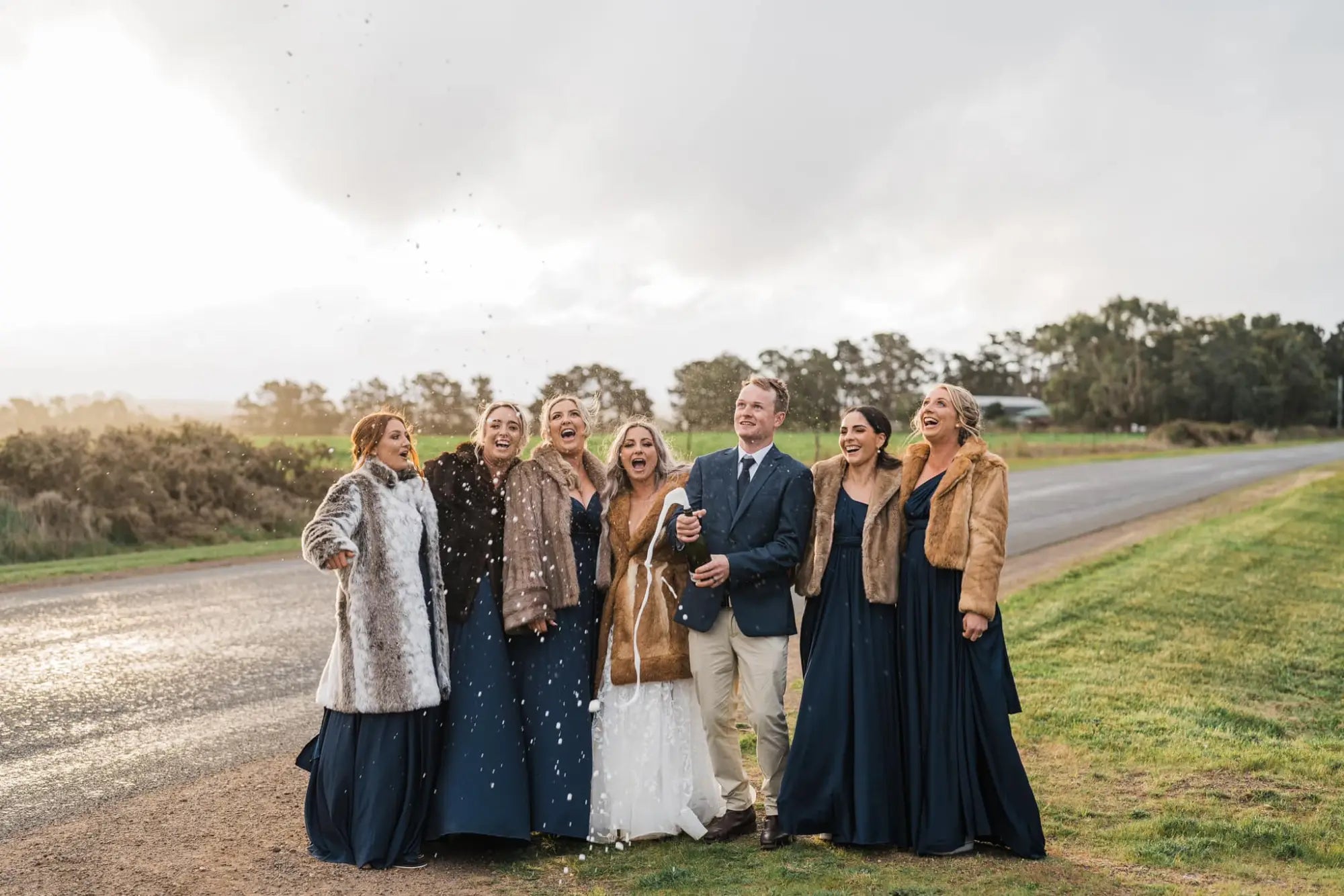 Celebrating outdoors with a bride in a white infinity dress Australia and groom in formal attire