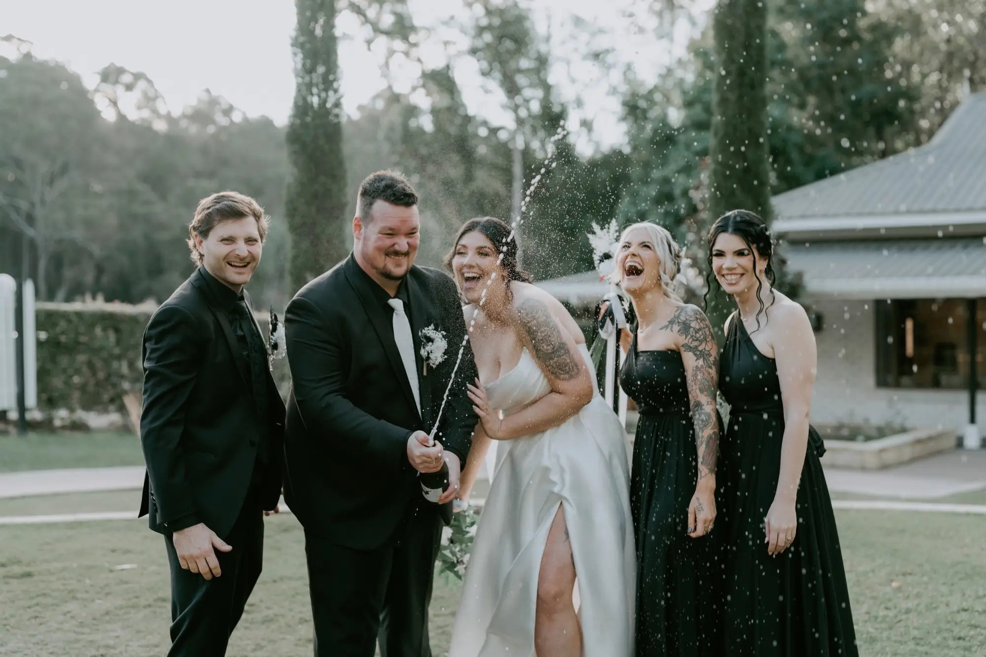 Wedding party celebrating with champagne wearing elegant infinity dress Australia for Hope and Mitch