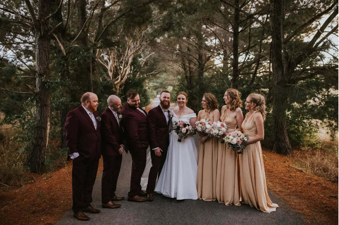 Wedding party outdoors with Jacinta and Jared wearing stylish infinity dresses in Australia