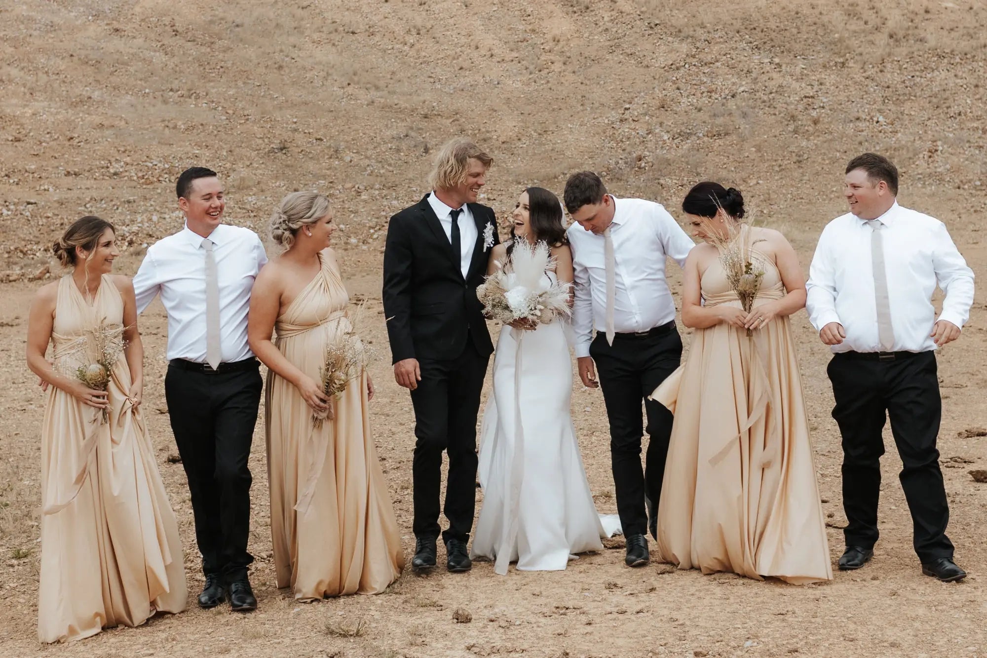 Wedding party in formal attire wearing infinity dresses at James and Tara’s wedding