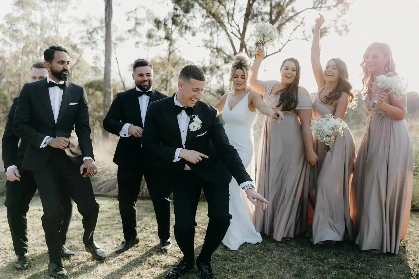 Wedding party dancing outdoors in luxe satin champagne with infinity dress Australia