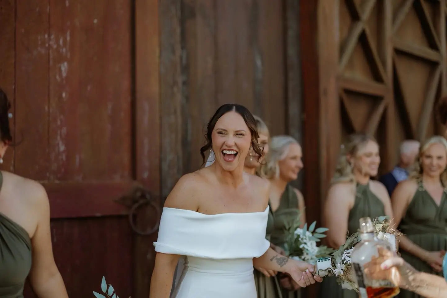 Jubilant bride in white off-the-shoulder wedding gown, perfect for infinity dress Australia
