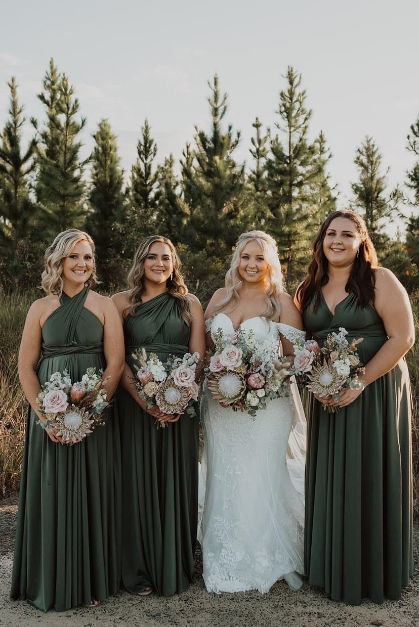 Four women outdoors in Olive Infinity Gown multiway bridesmaid and convertible dresses