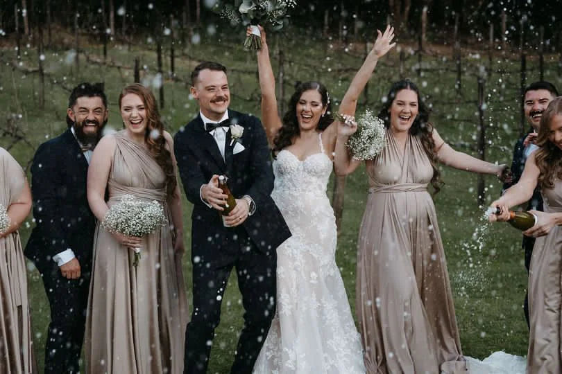 Wedding party celebrating with champagne in Gold Infinity Gown, perfect bridesmaid dress Australia